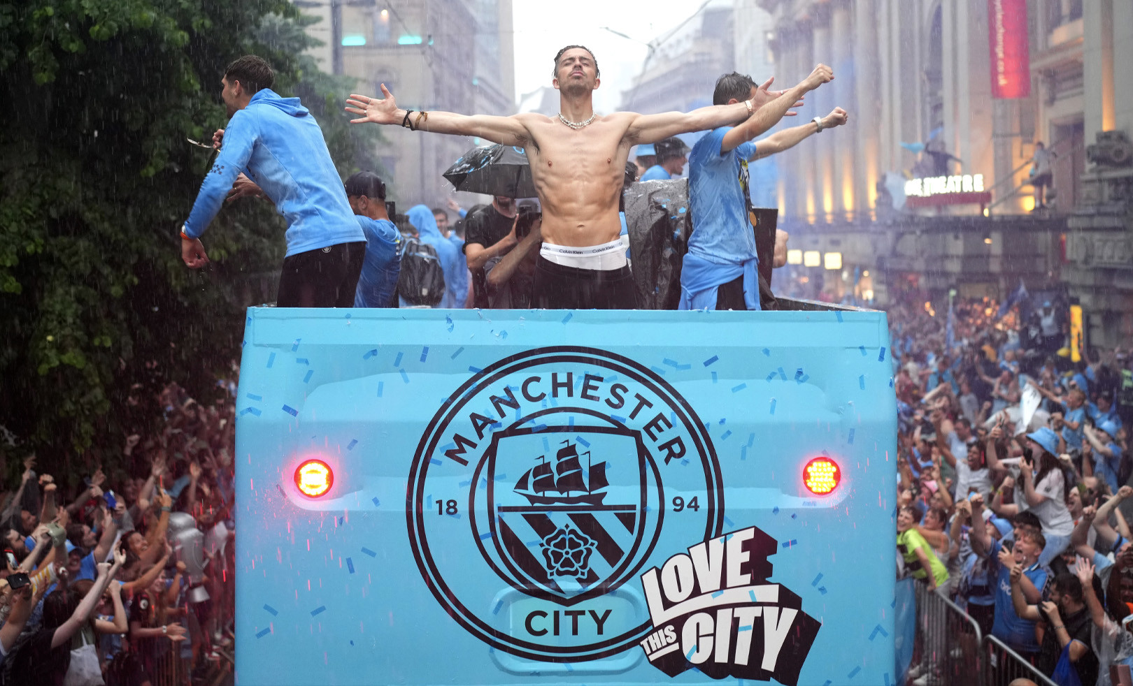 Jack Grealish on top of City's treble winning celebration bus