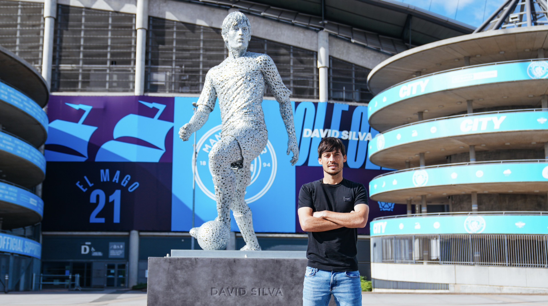 David Silva in front of his statue at Man City stadium